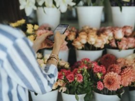 Woman messaging in a flower shop